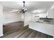 Open-concept living space with a dining area, kitchen, and a cozy living room area at 7972 Woodlake Dr, Riverdale, GA 30274