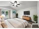 Bright main bedroom featuring vaulted ceilings, a ceiling fan, and ample natural light at 7972 Woodlake Dr, Riverdale, GA 30274