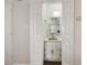 Small powder room with a vanity and mirrored shelving for storage at 7972 Woodlake Dr, Riverdale, GA 30274