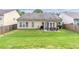 Wide angle view of fenced in backyard including patio with seating and barbeque at 918 Harvest Brook Dr, Lawrenceville, GA 30043