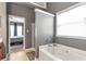 Bright bathroom with a soaking tub, and a view into the main bedroom at 918 Harvest Brook Dr, Lawrenceville, GA 30043
