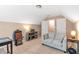 Bedroom with vaulted ceilings is set up as living area with a comfortable gray sofa at 918 Harvest Brook Dr, Lawrenceville, GA 30043