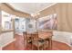 Traditional dining room with wainscoting, a chandelier, and hardwood flooring create an inviting atmosphere at 918 Harvest Brook Dr, Lawrenceville, GA 30043