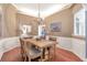 Traditional dining room with wainscoting, a chandelier, and hardwood flooring create an inviting atmosphere at 918 Harvest Brook Dr, Lawrenceville, GA 30043