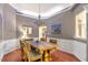 Traditional dining room with wainscoting, a chandelier, and hardwood flooring create an inviting atmosphere at 918 Harvest Brook Dr, Lawrenceville, GA 30043