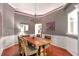 Traditional dining room with wainscoting, a chandelier, and hardwood flooring create an inviting atmosphere at 918 Harvest Brook Dr, Lawrenceville, GA 30043