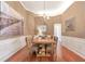 Traditional dining room with wainscoting, a chandelier, and hardwood flooring create an inviting atmosphere at 918 Harvest Brook Dr, Lawrenceville, GA 30043