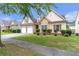 Attractive home with a manicured lawn, stone accents, and a two-car garage in a friendly neighborhood at 918 Harvest Brook Dr, Lawrenceville, GA 30043