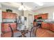 Eat-in kitchen with stainless steel appliances, wood cabinets, hardwood flooring, and a glass table with seating at 918 Harvest Brook Dr, Lawrenceville, GA 30043