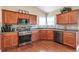 The kitchen features wood cabinetry, stainless steel appliances, and a stylish tiled backsplash at 918 Harvest Brook Dr, Lawrenceville, GA 30043
