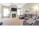 Spacious living room featuring a cozy fireplace, large windows, and comfortable seating at 918 Harvest Brook Dr, Lawrenceville, GA 30043