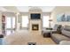 Spacious living room featuring a cozy fireplace, large windows, and comfortable seating at 918 Harvest Brook Dr, Lawrenceville, GA 30043