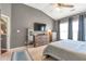 Spacious main bedroom with a ceiling fan, television, and plenty of natural light at 918 Harvest Brook Dr, Lawrenceville, GA 30043