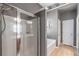 Bathroom with a glass door shower, soaking tub, and a decorative anchor at 918 Harvest Brook Dr, Lawrenceville, GA 30043