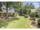 Spacious backyard with lush grass, a mature shade tree, and privacy fence at 1875 Conners Ct, Lawrenceville, GA 30044