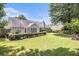 A spacious backyard features a well-manicured lawn, trimmed hedges, and a cozy patio area for outdoor enjoyment at 1875 Conners Ct, Lawrenceville, GA 30044