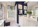 Bathroom with dual sinks, white cabinets, and a separate shower stall at 1875 Conners Ct, Lawrenceville, GA 30044