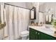 Updated bathroom with green vanity and modern decor, complete with shower and tub combination at 1875 Conners Ct, Lawrenceville, GA 30044