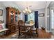 Elegant dining room featuring a chandelier, wood floors and trim, and a large wooden china cabinet at 1875 Conners Ct, Lawrenceville, GA 30044
