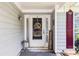 Charming front door with sidelights and a 'Home Sweet Home' wreath and gray siding at 1875 Conners Ct, Lawrenceville, GA 30044