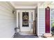 Charming front porch with decorative elements, complemented by stylish door decor and coordinated exterior accents at 1875 Conners Ct, Lawrenceville, GA 30044
