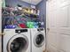 Functional laundry area with front-loading washer/dryer and overhead storage shelf at 1875 Conners Ct, Lawrenceville, GA 30044