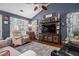 Comfortable living room features a vaulted ceiling, ceiling fan, and entertainment center at 1875 Conners Ct, Lawrenceville, GA 30044