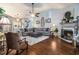Inviting living room with hardwood floors, a fireplace, large windows, and stylish furnishings at 1875 Conners Ct, Lawrenceville, GA 30044