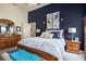 Main bedroom featuring a statement wall, ceiling fan, and ensuite bathroom at 1875 Conners Ct, Lawrenceville, GA 30044