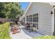 Home exterior with a charming patio set, swing, and well maintained landscaping at 1875 Conners Ct, Lawrenceville, GA 30044