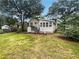 Spacious backyard featuring a cozy porch, mature trees, and lush green grass at 5021 Rodrick Trce, Marietta, GA 30066