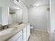 Well-lit bathroom with double sinks, a large mirror, and tiled floors at 5021 Rodrick Trce, Marietta, GA 30066