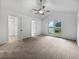 Bright bedroom featuring neutral carpet, ceiling fan, and walk-in closet at 5021 Rodrick Trce, Marietta, GA 30066