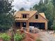 Framed house under construction shows its dormer and the structure before siding or brick is applied at 6134 Linwood Dr, Covington, GA 30014