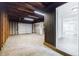 Unfinished basement offering exposed beams, wood frame construction, and access to the rest of the home at 766 Brian Ln, Forest Park, GA 30297
