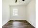 Bedroom featuring a ceiling fan, a window, wood-look floors, and white walls to make you feel at home at 766 Brian Ln, Forest Park, GA 30297