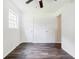 Cozy bedroom featuring wood-look floors, a ceiling fan, and two closets for lots of storage space at 766 Brian Ln, Forest Park, GA 30297