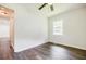 Bedroom featuring wood-look floors, a ceiling fan, a window, and fresh white walls at 766 Brian Ln, Forest Park, GA 30297