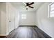 Bedroom boasts wood-look floors, ceiling fan, a window, and fresh white walls creating a serene atmosphere at 766 Brian Ln, Forest Park, GA 30297