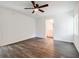 Bright bedroom boasts modern ceiling fan, wood-look floors, and leads to updated bathroom at 766 Brian Ln, Forest Park, GA 30297