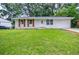 Charming single-story home with a well-maintained lawn and mature trees in a desirable neighborhood at 766 Brian Ln, Forest Park, GA 30297