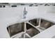 Close-up of a modern stainless steel kitchen sink with granite countertops and a stylish backsplash at 766 Brian Ln, Forest Park, GA 30297