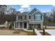 Charming two-story brick home with a covered porch and professionally landscaped front yard at 113 Maplewood Ln, Conyers, GA 30094