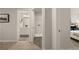 Neutral-toned hallway leading to a laundry room and bathroom, showcasing a seamless transition at 113 Maplewood Ln, Conyers, GA 30094
