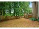 Spacious backyard featuring a wooden deck, lush greenery, and a privacy fence at 507 Mirramont Pl, Woodstock, GA 30189