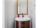 Charming powder room featuring a wood vanity, white sink, stylish gold mirror, and gray walls at 507 Mirramont Pl, Woodstock, GA 30189