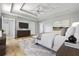 Primary bedroom featuring hardwood floors, neutral paint, large windows and en suite bathroom at 507 Mirramont Pl, Woodstock, GA 30189