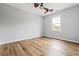 Bedroom with new vinyl flooring, a ceiling fan and a window with a view to the outside at 507 Mirramont Pl, Woodstock, GA 30189