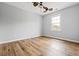 Bedroom featuring a ceiling fan, window and wood-look flooring at 507 Mirramont Pl, Woodstock, GA 30189
