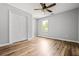Bedroom featuring a ceiling fan, closet and wood-look flooring at 507 Mirramont Pl, Woodstock, GA 30189